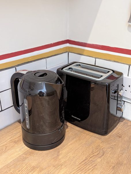 Kettle and toaster Black kettle and toaster placed on a kitchen countertop.