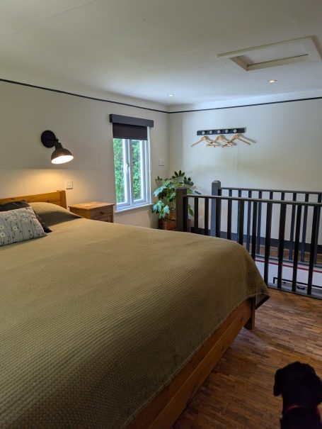 Cosy bedroom with Emperor Bed Cozy bedroom with a double bed, plants, and natural light from a window.